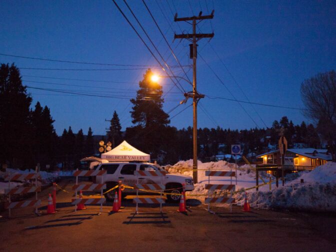 San Bernardino Sheriff's officials stand guard outside the condo where murder suspect Christopher Dorner reportedly hid from police near Bear Mountain Ski Resort.