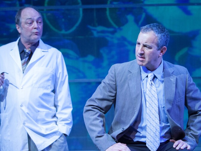 In this scene Ron Bottitta's character (left) tells Bruce Nozick's (right) about "Driscotol," an invented drug that cures racism.