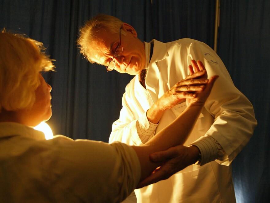 A doctor checks for signs of skin cancer at a free cancer screening day in New York City.