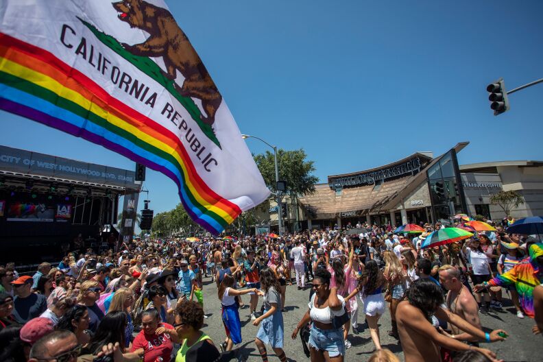 A group of people participate in the annual LA Pride Parade in West Hollywood, California, on June 9, 2019.