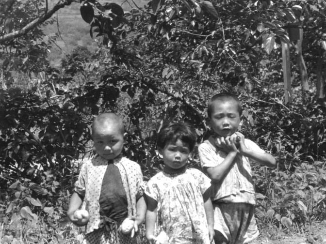 In Aizu, Japan, Hirono is pictured in the middle with her brother Roy to the right.