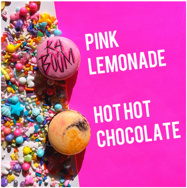 This promo for the BakeCamp Los Angeles event shows a hot pink background sliced diagonally in two, and features two different macarons sitting atop candies made to look like pastel colored jewels: One bright pink macaron has the word KA BOOM written on it in edible ink, while the other is a tie dye swirl of orange, pink and chocolate. The words on the background say: "Pink Lemonade and "Hot Hot Chocolate," designating the macaron flavors.