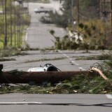 PASADENA, CA - DECEMBER 1:  Fallen power poles block a street as strong Santa Ana Winds cause the worst local wind damage in decades on December 1, 2011 in Pasadena, California. As many as 230,000 were without power and the city of Pasadena closed schools and declared a state of emergency. (Photo by David McNew/Getty Images)