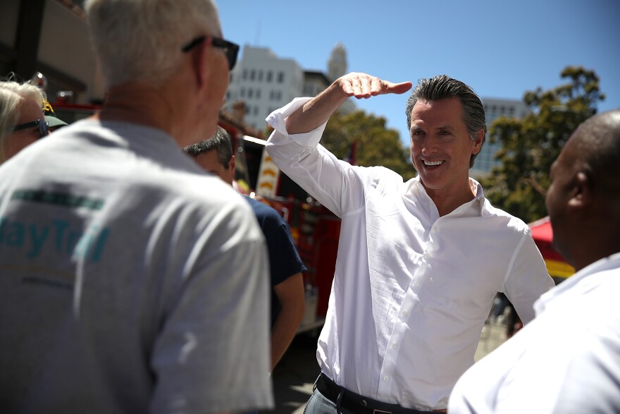 OAKLAND, CA - JUNE 02:  California Lt. Gov. and democratic candidate for California governor Gavin Newsom (C) greets supporters during a campaign stop at California Assemblyman Rob Bonta's Chili Cook Off on June 2, 2018 in Oakland, California.  With less than a week to go until the California primary, Gavin Newsom is campaigning throughout the state.  (Photo by Justin Sullivan/Getty Images)