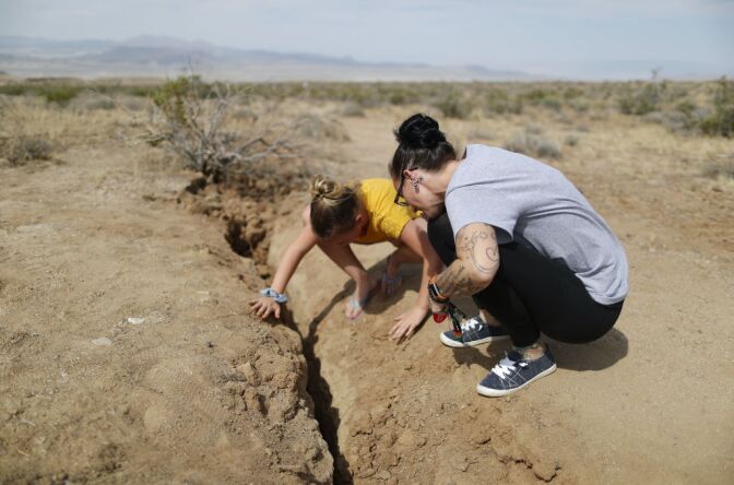 RIDGECREST, CALIFORNIA - JULY 07: Ridgecrest residents inspect a recent fault rupture following two large earthquakes in the area on July 7, 2019 near Ridgecrest, California. A 6.4 magnitude 'foreshock' on July 4 was followed by a 7.1 magnitude earthquake the next day. The 7.1 magnitude temblor was the largest in Southern California in twenty years.  (Photo by Mario Tama/Getty Images)
