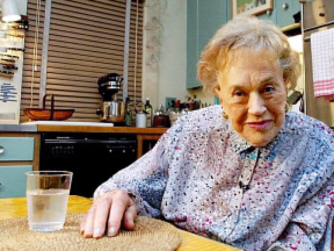 Julia Child sits in her kitchen on August 19, 2002, after it was moved from Cambridge, Massachusetts, and rebuilt as an exhibit marking her 90th birthday at the National Museum of American History in Washington, DC. 