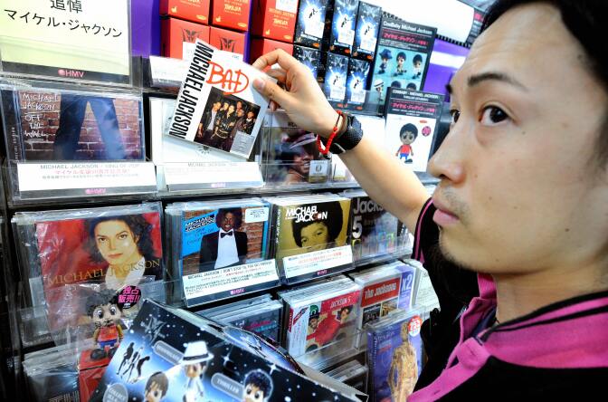 HMV salesclerk Yoshio Nishimura arranges CD's by US pop legend legend Michael Jackson in Tokyo on June 26, 2009 following the news of his death in Los Angeles.  