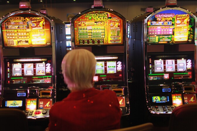 COCONUT CREEK, FL - DECEMBER 17:  Marge Lesinski plays a slot machine during the grand opening of the newest building at the Seminole Casino Coconut Creek on December 17, 2010 in Coconut Creek, Florida. The site offers up an additional 400-plus gaming positions, a new restaurant and a new venue with more space to gamble, dine and party.  (Photo by Joe Raedle/Getty Images) *** Local Caption *** Marge Lesinski