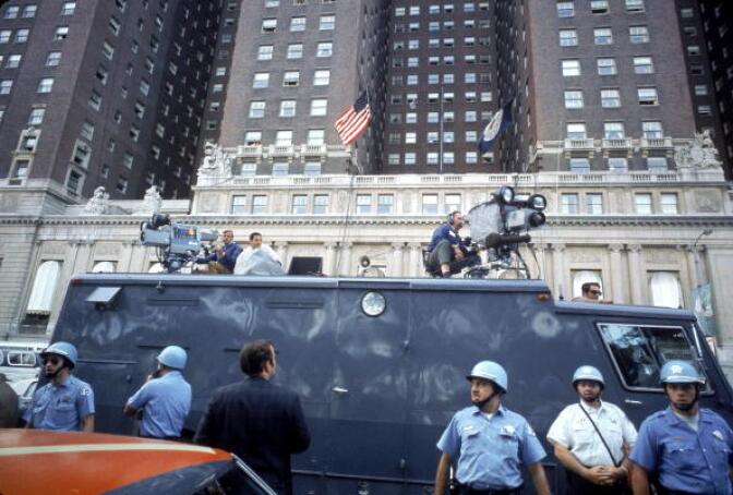 News crew atop truck behind police during the 1968