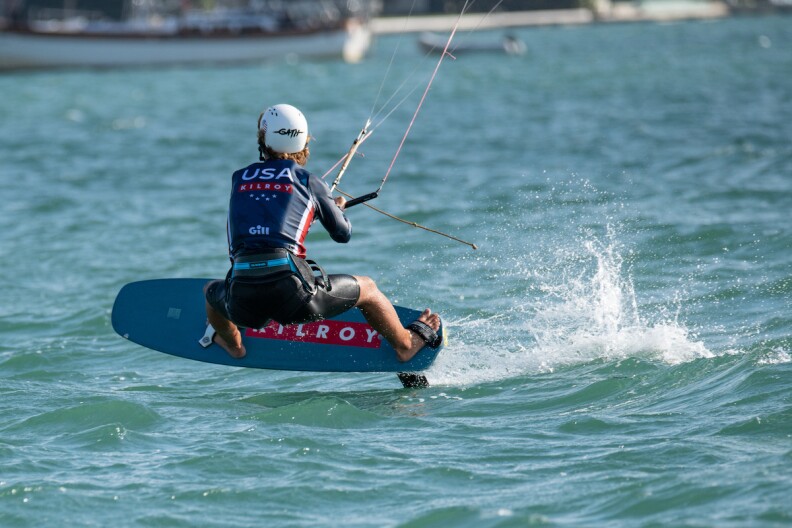 A kiteboarder rides the waves