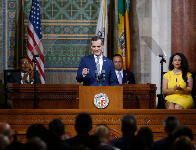 Los Angeles Mayor Eric Garcetti, center, delivers his State of the City address in Los Angeles, Monday, April 16, 2018. (AP Photo/Damian Dovarganes)