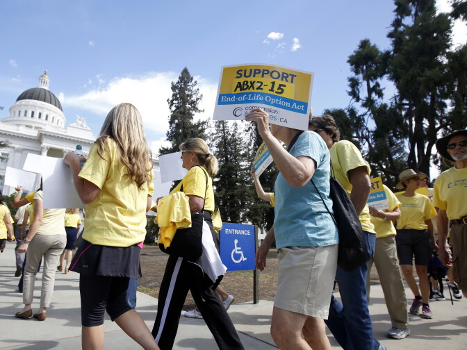 Supporters of a measure to allow the terminally ill to end their own life march at the Capitol while calling on California Gov. Jerry Brown to sign the bill Thursday, Sept. 24, 2015, in Sacramento, Calif.