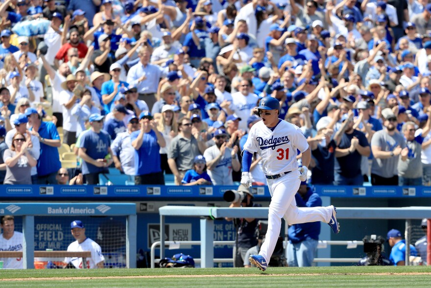 Joc Pederson approaches home plate after hitting a grand slam during the third inning of an Opening Day game against the San Diego Padres at Dodger Stadium on April 3, 2017 in Los Angeles, California.