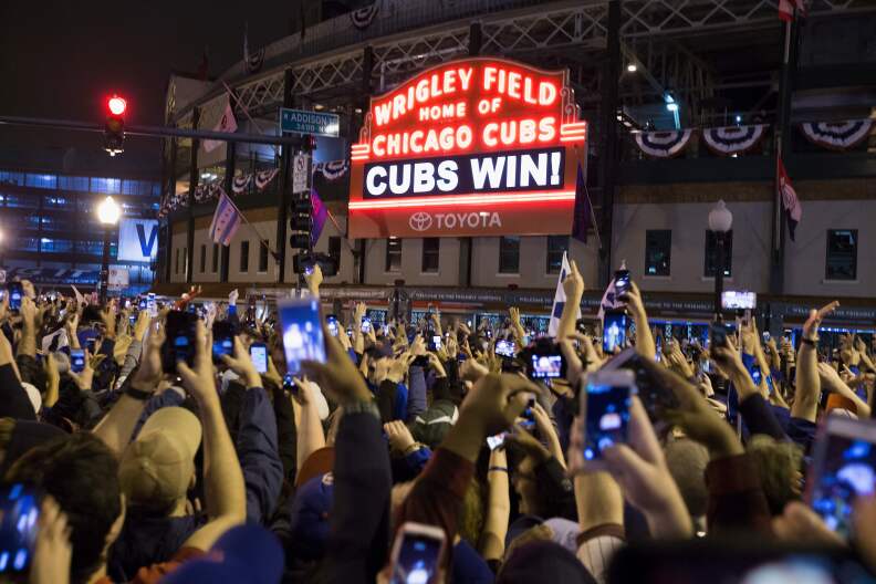 Chicago fans celebrate the Chicago Cubs 8-7 victory over the Cleveland Indians in Cleveland in 10th inning in game seven of the 2016 World Series, outside Wrigley Field in Chicago, Illinois early on November 3, 2016.
Ending America's longest sports title drought in dramatic fashion, the Chicago Cubs captured their first World Series since 1908 by defeating the Cleveland Indians 8-7 in a 10-inning thriller that concluded early on November 3. / AFP / Tasos Katopodis        (Photo credit should read TASOS KATOPODIS/AFP/Getty Images)