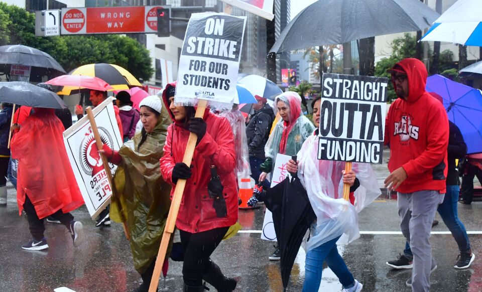 Thousands of teachers march in the rain through Los Angeles, California on January 14, 2019, on the first day of the first teachers strike in 30 years targeting the Los Angeles Unified School District (LAUSD). - Teachers of the LAUSD, the second largest public school district in the US, are striking for smaller class size, better school funding and higher teacher pay. (Photo by Frederic J. BROWN / AFP)        (Photo credit should read FREDERIC J. BROWN/AFP/Getty Images)