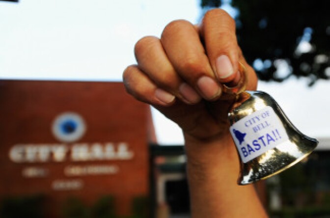 A resident celebrates the arrest of eight former and current city officials by shaking little bells in front of City Hall on September 21, 2010 in Los Angeles, California, The eight are charged with misappropriation of more than $5.5 million in public funds for excessive salaries and illegal personal loans.