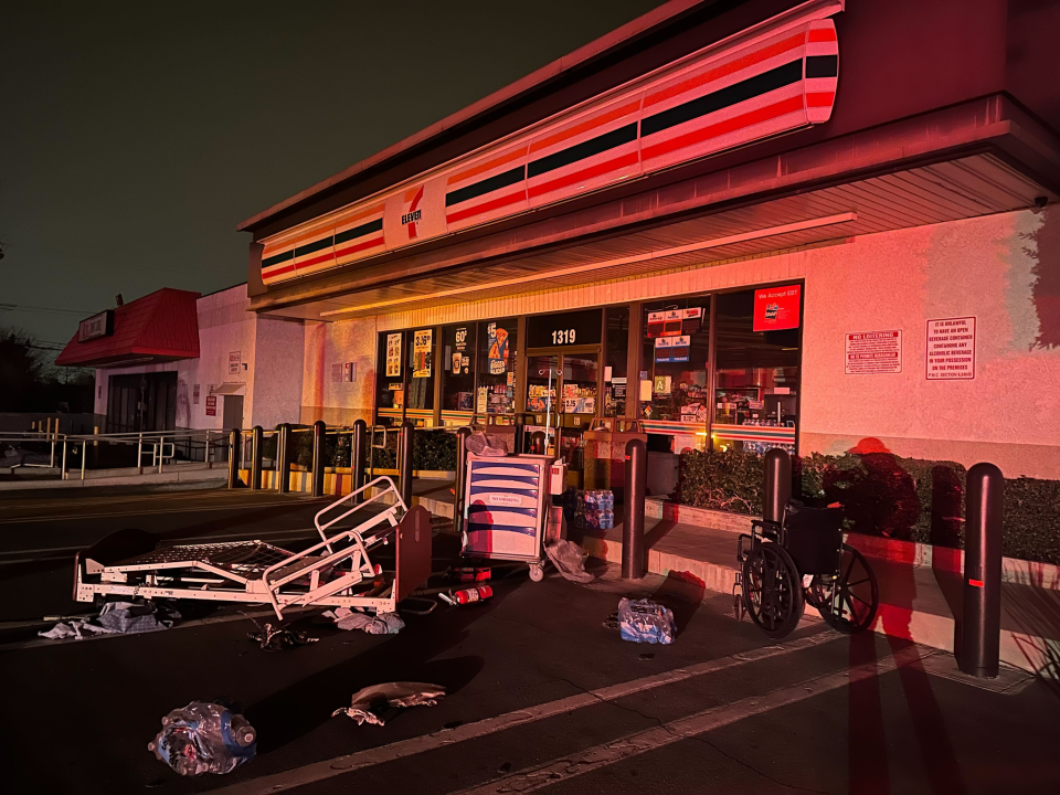 Medical equipment strewn in a parking lot outside a 7 Eleven convenience store 