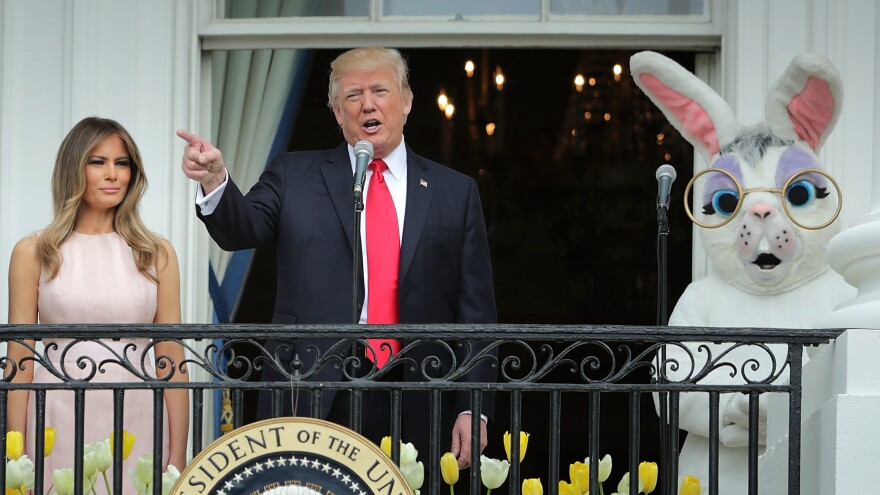 President Trump delivers remarks from the Truman Balcony with first lady Melania Trump and someone dressed as a bunny during last year's Easter Egg Roll on the South Lawn.