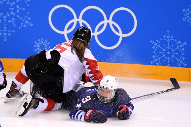 Cayla Barnes #3 of the United States and Rebecca Johnston #6 of Canada fall on the ice as they battle for the puck in the second period during the Women's Gold Medal Game at the 2018 Winter Olympic Games in Gangneung, South Korea.