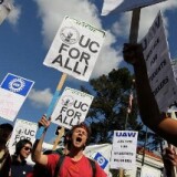 Students at UC Berkeley carry signs as they march through campus during a national day of action against funding cuts and tuition increases.