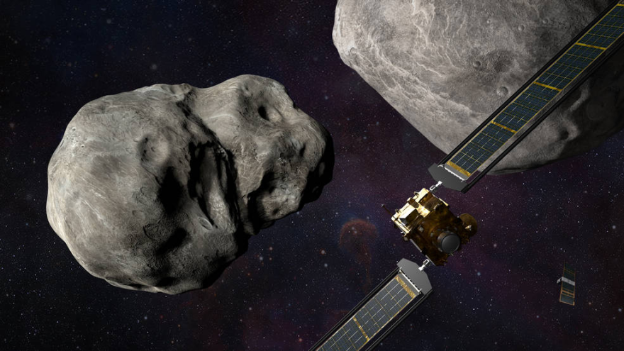 A computer generated image of a spacecraft with two large wing-like extensions headed toward a pair of asteroids floating in space.