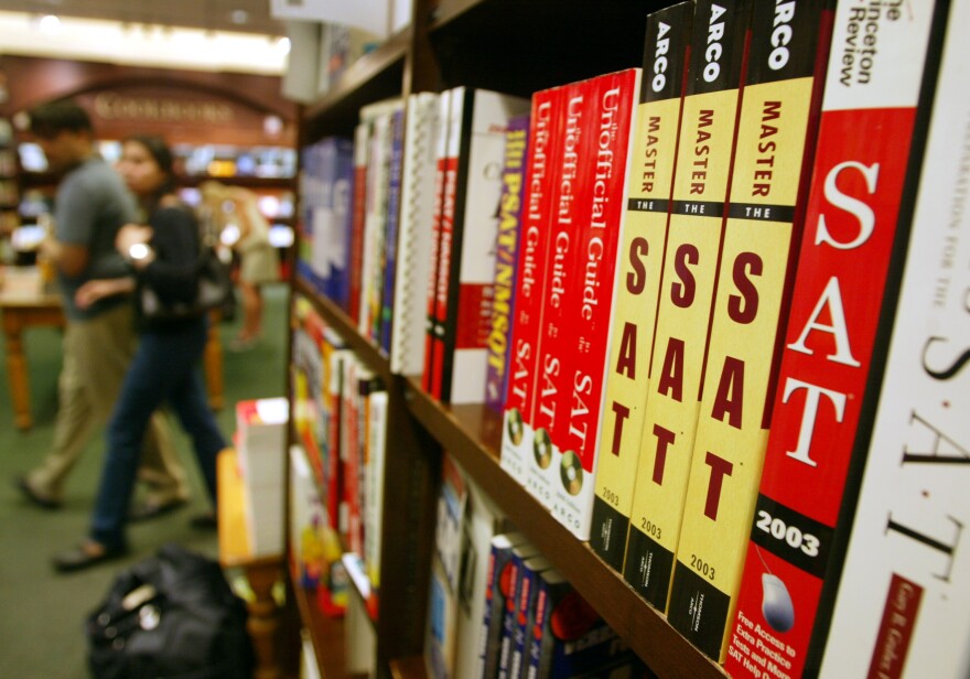 A bookshelf in a bookstore is lined with SAT exam preparation books.