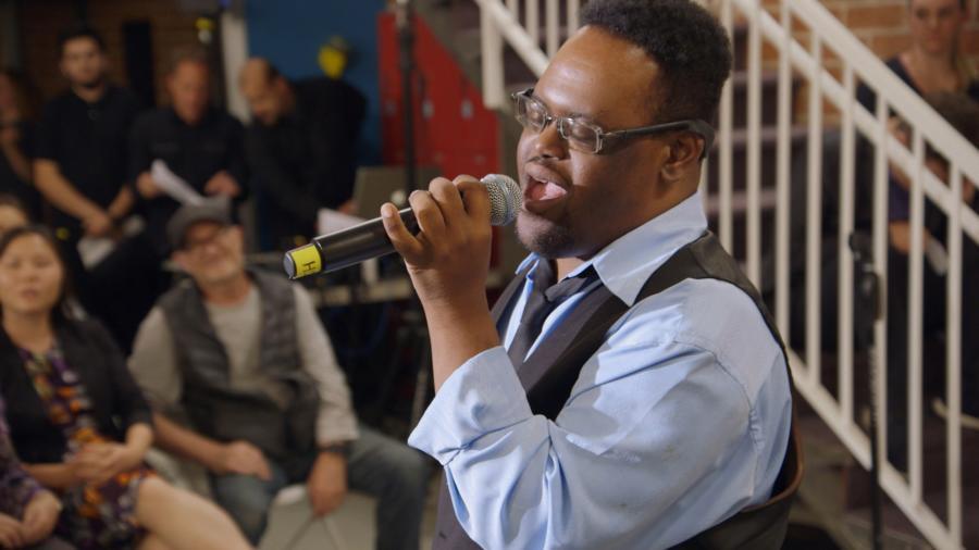 John Tucker sings at a fundraiser on the television series "Born This Way."