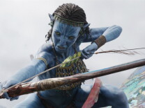 An blue Avatar character has cornrow braids and is wielding a bow and arrow, poised to shoot. \