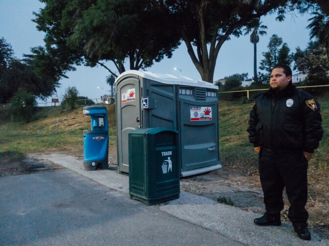 Bill Garcia with Premiere Security Group stands watch at the lot designated for safe parking at the West L.A. VA campus. 