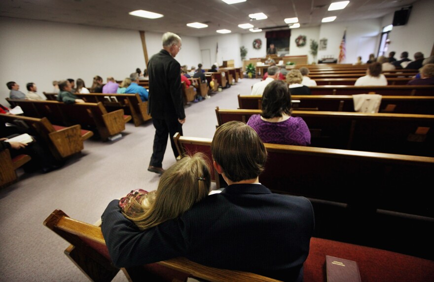 BOONEVILLE, KY - APRIL 22:  Parishioners gather as Sugar Camp Baptist Church pastor Tim Charlton preaches in Owsley County on April 22, 2012 in Booneville, Kentucky. Daniel Boone once camped in the Appalachian mountain hamlet of Owsley County which remains mostly populated by descendants of settlers to this day. The 2010 U.S. Census listed Owsley County as having the lowest median household income in the country outside of Puerto Rico, with 41.5% of residents living below the poverty line.  Familial and community bonds run deep, with a populace that shares a collective historical and cultural legacy uncommon in most parts of the country. However, the community of around 5,000 struggles with a lack of jobs due to the decline in coal, tobacco and lumber industries along with health issues including drug addiction without effective treatment  (Photo by Mario Tama/Getty Images)