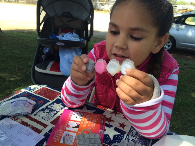 Karley Learned, 7, is creating bracelets with her mom and sister during Spring break at her home in Nuevo, CA. Karley had an eye removed as an infant. She sometimes gets teased by children at school. "Explain to him that you had cancer," her mother advises her. Jessica Learned is saddened by the treatment of her daughter. "She's only in first grade," she said. 