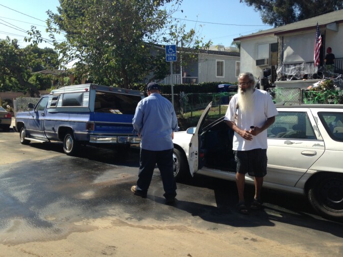 Longtime Bernal Avenue resident Manuel Medina obtained claim forms from a city sanitation worker for his car and his truck, both of which flooded when his street was filled with muddy water during Monday's sudden rainstorm.