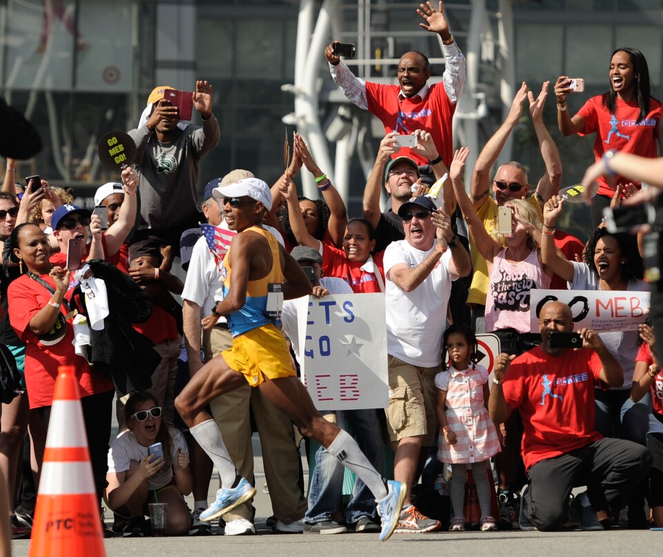 Meb Keflezighi runs past supporters in the U.S. Men's Olympic Marathon Trials on February 13, 2016 in Los Angeles, California.