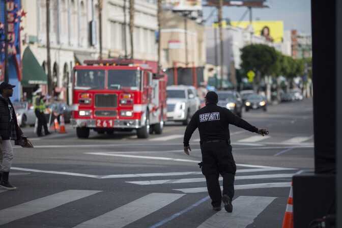 File: A security guard stops pedestrian traffic for an approaching fire truck on Hollywood Boulevard where preparations were being made for the premiere of Walt Disney Pictures And Lucasfilm's "Star Wars: The Force Awakens" on December 13, 2015 in the Hollywood section of Los Angeles.