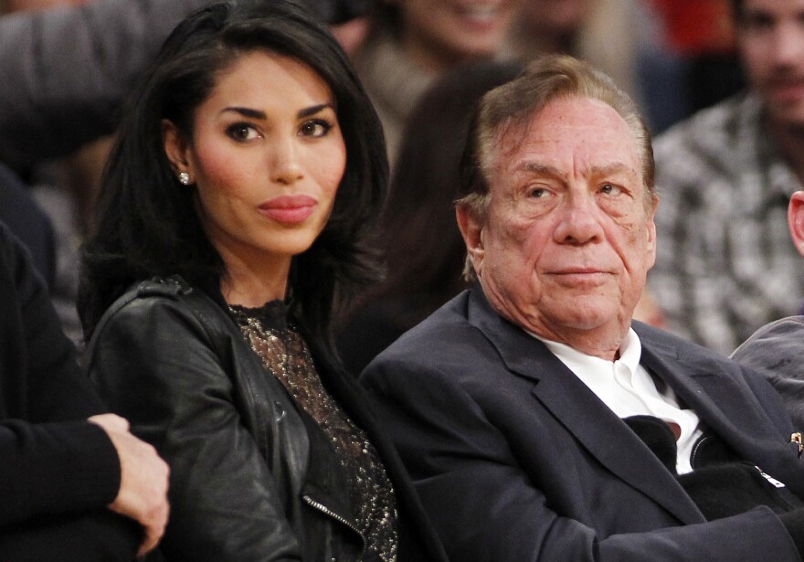 In this Dec. 19, 2010, file photo, Los Angeles Clippers owner Donald Sterling, right, and V. Stiviano, left, watch the Clippers play the Los Angeles Lakers during an NBA preseason basketball game in Los Angeles. NBA Commissioner Adam Silver is intent on moving quickly in dealing with the racially charged scandal surrounding Clippers owner Sterling. The NBA league will discuss its investigation Tuesday, April 29, 2014, before the Clippers play Golden State in Game 5 of their playoff series.  
