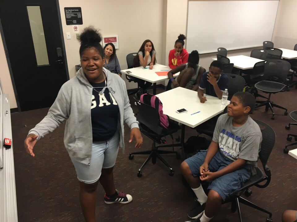 Samone Urasia Wade, 13, performs a poem about race and social justice she and a group of fellow seventh- and eighth-graders wrote together in a small classroom on the University of Southern California campus.