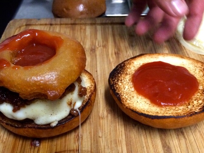 The Vaka Burger: A grass-fed patty, muenster cheese, bacon jam, a tempura battered onion ring and homemade BBQ sauce, all on a brioche bun.