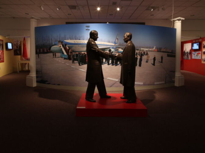 Two bronze statues of Richard Nixon and Chou en-Lai compliment a mural of Air Force One after it touched down in Peking, China in February 1972.
