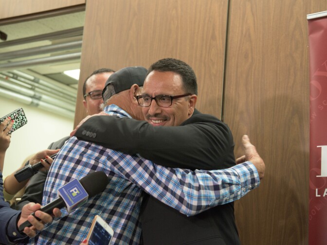 A newly-freed Marco Contreras hugs his father.