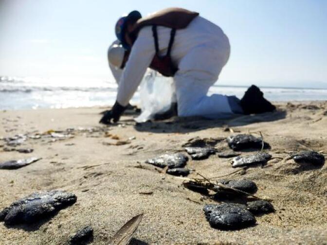 A two-mile stretch of beach was closed in Manhattan Beach May 27, 2015 after balls of what were thought to be oil began washing ashore.