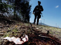 A member of the state police stands on May 23, 2015 by a bloodstain during a search for evidence inside the ranch along the Jalisco-Michoacan highway in Tanhuato, Michoacan State, Mexico where gunmen took cover during an intense gun battle with police. Mexican federal forces killed at least 42 suspected cartel members Friday — with only one police officer dead — during a three-hour gunfight on a ranch in a violence-torn western region, marking one of the drug war's bloodiest battles.