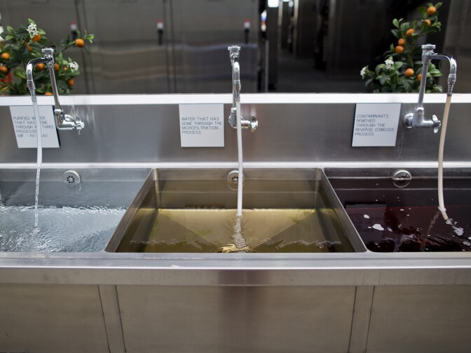 Water after each step of the three-part recycling process, from right to left. The left sink holds the final purified water that comes from Orange County's water recycling facility.