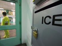 An immigration detainee stands near an US Immigration and Customs Enforcement (ICE) grievance box in the high security unit at the Theo Lacy Facility, a county jail which also houses immigration detainees arrested by the US Immigration and Customs Enforcement  (ICE), March 14, 2017 in Orange, California, about 32 miles (52km) southeast of Los Angeles. 
US President Donald Trumps first budget provides more than USD 4.5 billion in new spending to fight illegal immigration by adding immigration and border enforcement agents, prosecutors and judges, as well as building a wall on the border with Mexico. / AFP PHOTO / Robyn Beck        (Photo credit should read ROBYN BECK/AFP/Getty Images)
