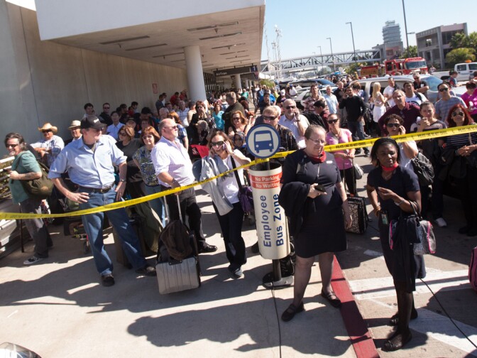 Passengers wait at Terminal 1 after the LAX shooting on Nov. 1, 2013.