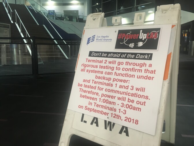 A placard in Terminal 2 notifies LAX passengers that terminals 1, 2 and 3 would be without normal power during a test of backup generators at the airport early Sept. 12, 2018.