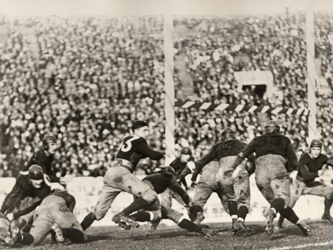 In 1923, USC and Penn State had the honor of playing the first New Year's Day game in the Rose Bowl. In this photograph, USC fullback Joseph Campbell (No. 33) runs to Penn State's one-yard line. Although the play resulted in three points for Penn State, USC ultimately won the game 14-3.