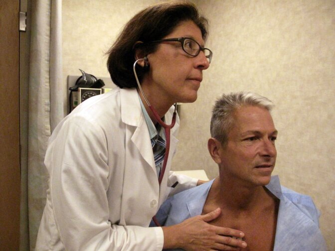 Internist Nesli Basgoz examines patient Barry Arcangeli who has a leaky heart valve. Basgoz discovered Arcangeli's heart condition during a routine physical examination.