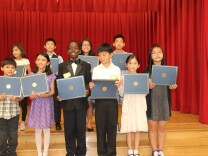 Kevon Fortune, center, stands with other violin students who received scholarships for private lessons. 