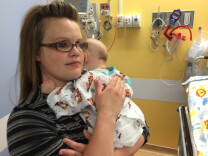 Jessica Learned comforts her 4 month old son, Kaleb, as they wait in the pro-op cubicle at Children's Hospital awaiting Kaleb's second eye exam under anesthesia. 