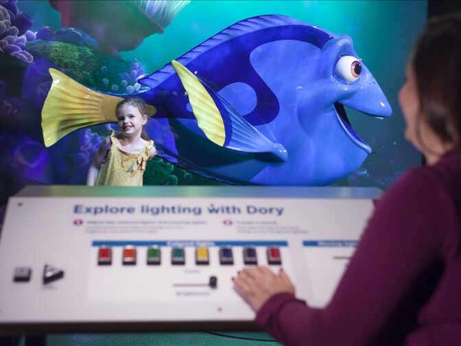 Visitors adjust the lighting for their photo with Dory.